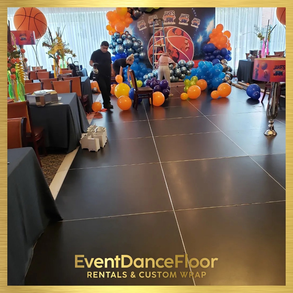 What are the benefits of using a carpeted dance floor over a traditional hardwood floor?